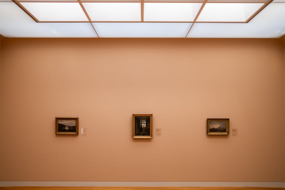 Minimalist art exhibition showcasing framed paintings on a gallery wall.