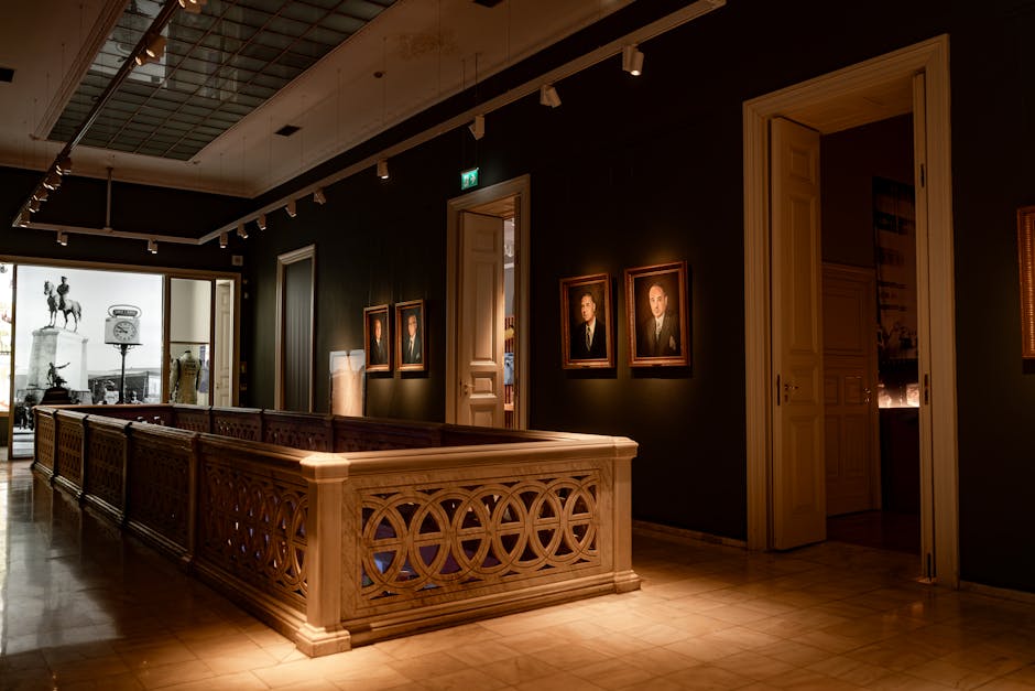 Beautiful art gallery interior featuring classic portraits and sculptures in dim lighting.
